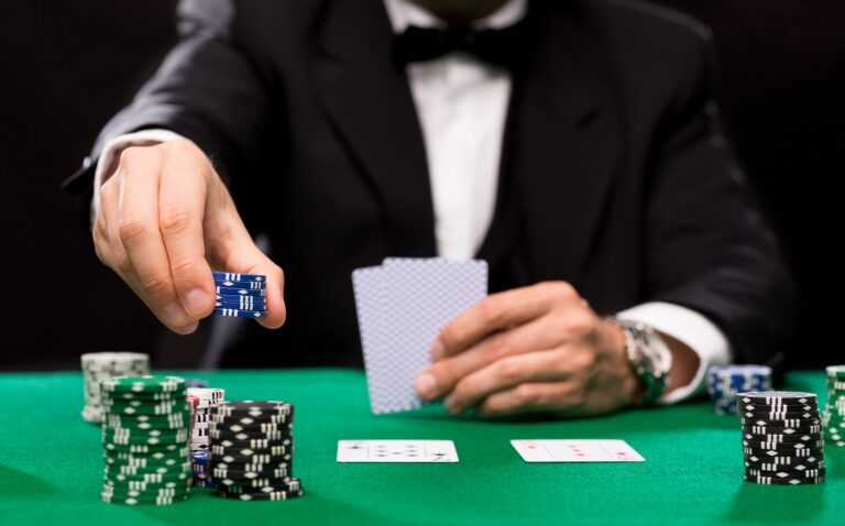 casino-gambling-poker-people-entertainment-concept-close-up-poker-player-with-playing-cards-chips-green-casino-table (1)